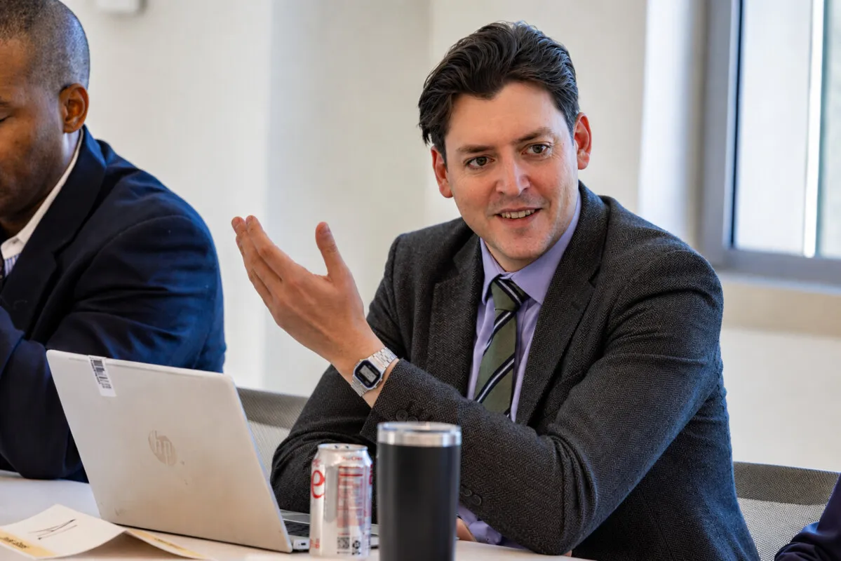Al Hynes in strategic discussion with colleagues